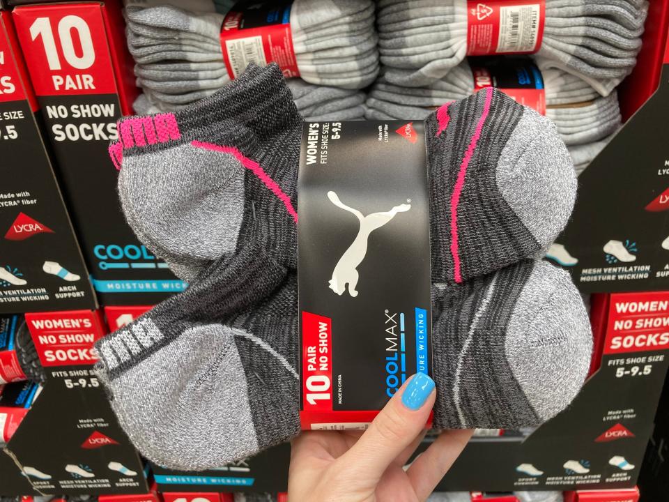 hand holding package of puma athletic socks at costco