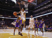 Tennessee guard Kennedy Chandler (1) passes the ball off as he's defended by LSU center Efton Reid (15) (behind)04 during the first half of an NCAA college basketball game Saturday, Jan. 22, 2022, in Knoxville, Tenn. (AP Photo/Wade Payne)