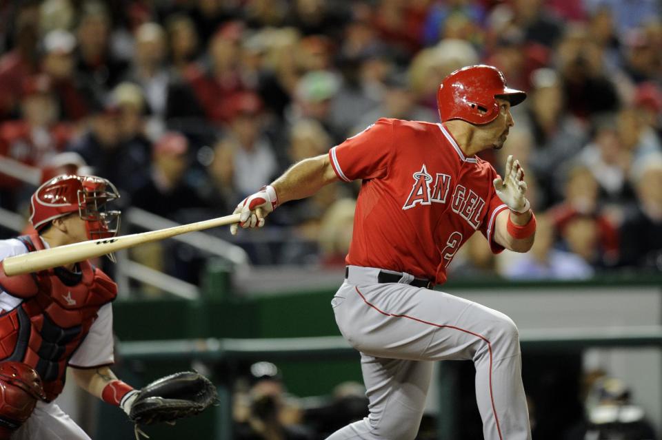 Los Angeles Angels' Raul Ibanez follows through on his double that drove in three runs during the eighth inning of a baseball game against the Washington Nationals, Monday, April 21, 2014, in Washington. Ibanez advanced to third on a throwing error by Washington Nationals shortstop Ian Desmond. The Angels won 4-2. (AP Photo/Nick Wass)