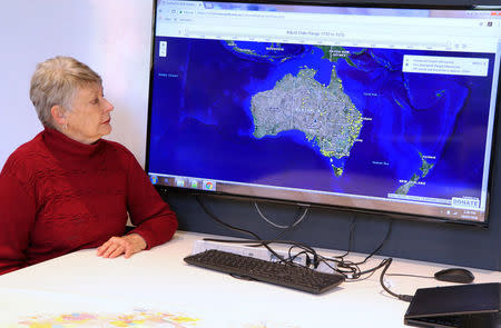A supplied image shows University of Newcastle research academic, Professor Lyndall Ryan, sitting in front of a screen July 18, 2018, displaying a map detailing the number of Aboriginal and Torres Strait Islander massacres that occurred on Australia’s colonial frontier. Picture taken July 18, 2018. University of Newcastle/Handout via REUTERS