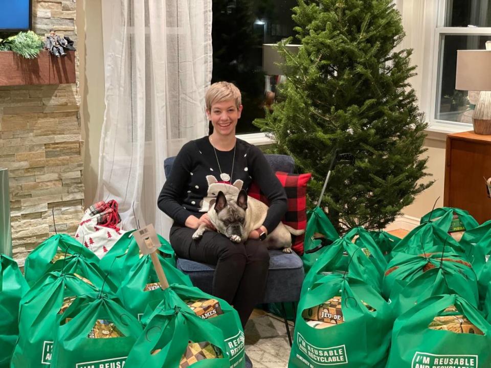 Kayleigh Reynolds, owner of Maid to Sparkle, is pictured with previous Santa to a Senior donations. (Submitted by Kayleigh Reynolds - image credit)