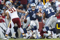 Dallas Cowboys quarterback Dak Prescott (4) scrambles with the ball during the first half of an NFL football game against the Washington Redskins, Sunday, Oct. 21, 2018, in Landover, Md. (AP Photo/Andrew Harnik)