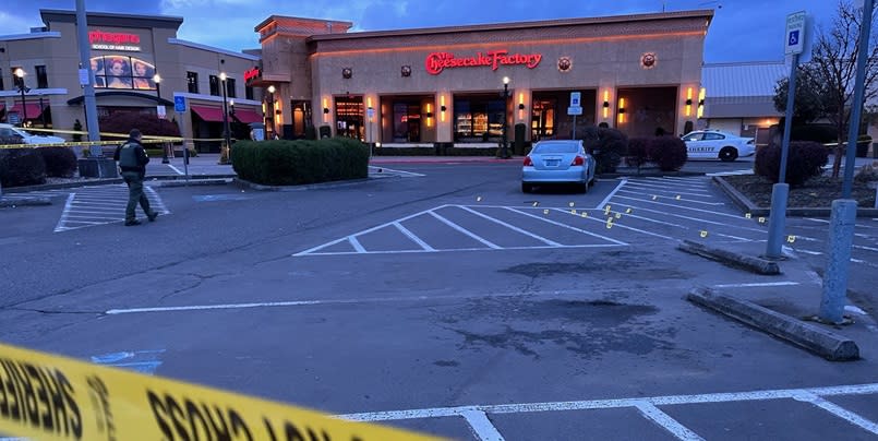 Evidence markers note shell casings in the parking lot of the Clackamas Town Center outside the Cheesecake Factory, April 7, 2024 (KOIN)