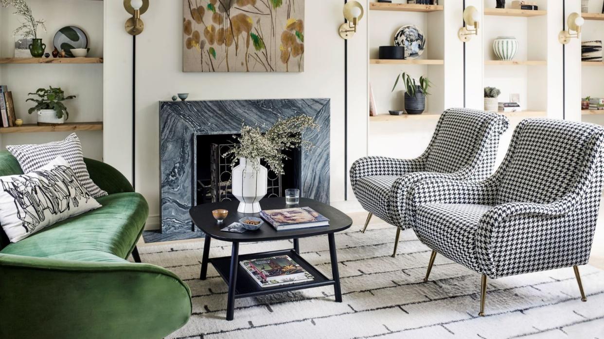  Living room with black and white chairs and green sofa 