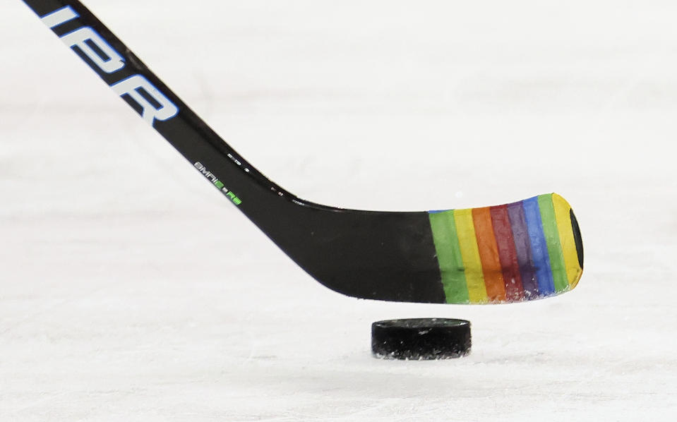 FILE - Zac Jones of the New York Rangers skates with a stick decorated for "Pride Night" in warm-ups prior to the game against the Washington Capitals, May 3, 2021, in New York City. NHL players will be allowed to use Pride tape this season after all. The league, union and a committee on inclusion agreed Tuesday, Oct. 24, 2023, to give players the option to represent social causes with stick tape during warmups, practices and games. (Bruce Bennett/Pool Photo via AP, File)