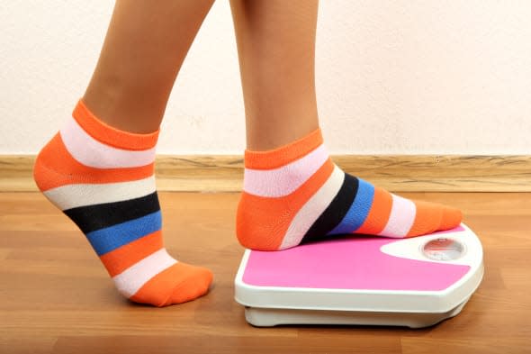 feet on scales on floor in room