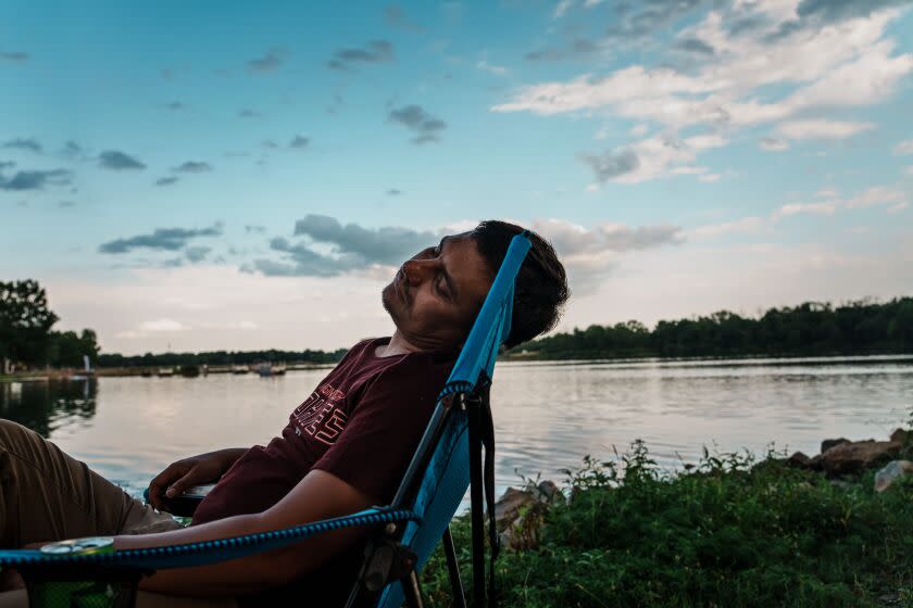 DES MOINES, UNITED STATES OF AMERICA -- AUGUST 7, 2022: Shir Agha Safi, 30, takes a moment to relax at a park near Des Moines, Iowa, Sunday, Aug. 7, 2022. Safi, an Afghan military commander who used to lead men into battle against insurgent and terrorists in Helmand Province, Afghanistan, is now a refugee who arrived in Iowa wanting to disassociate from the trauma and burden of war. But soon enough as the influx of Afghan refugees increased, Safi was joined by other Afghan refugees in the motel that he was initially living in. One day an Afghan man tried crossing the road but did not know the traffic laws and was killed by a passing car. Safi realized that he needed to do something and has since started a non-profit organization called Afghan Partners in Iowa, that aims to train Afghan refugees who speak English to help fellow Afghans refugees with their needs and challenges. Like a commander in the battlefield previously, Safi is now leading his fellow Afghan to rebuild new lives in the United States. (MARCUS YAM / LOS ANGELES TIMES)