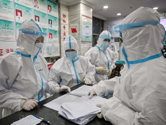 Medical staff at the Wuhan Red Cross hospital wearing protective clothing (AFP via Getty Images)