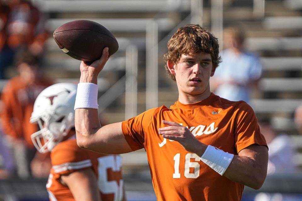 Texas quarterback Arch Manning warms up ahead of last week's Red River Rivalry game with Oklahoma in Dallas. The freshman donated $102,500 on Tuesday to the Ronald McDonald House Charities, proceeds from his first NIL deal.