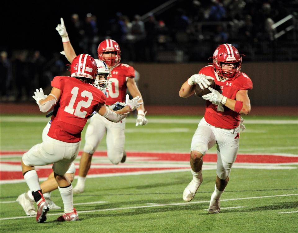 Albany's Coy Lefevre, right, picks off a pass as Adam Hill, center, celebrates and Cooper Fairchild (12) blocks a Windthorst player. The pick set the Lions up at the Windthorst 29-yard line. Three plays later, Lefevre caught a 28-yard TD pass from Cole Chapman for his second of the game. It gave the Lions a 28-6 lead with 4:07 left in the third quarter. Albany won the Region II-2A Division II championship 28-14 at Newton Field in Graham.