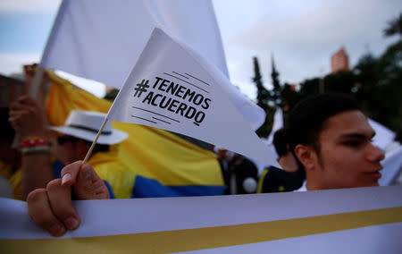 A supporter rallying for the nation’s new peace agreement with FARC holds a sign reading "We have an agreement" during a march in Bogota, Colombia, November 15, 2016. REUTERS/John Vizcaino