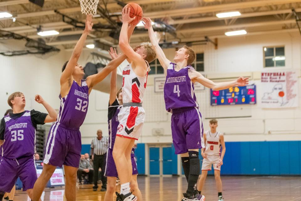 Canisteo-Greenwood sophomore Carson Chaffee puts up a shot between Hammondsport defenders Saturday night as the No. 1-seeded Chargers claimed a spot in the county championship against the A-P Titans. Chafee finished the night with 29 points and was also named to the All-County team this season.