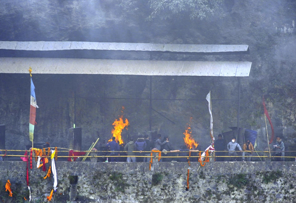 Relatives and friends perform last rites of the plane crash victims, in Pokhara, Nepal, Wednesday, Jan.18, 2023. Nepalese authorities are returning to families the bodies of plane crash victims and are sending the aircraft's data recorder to France for analysis as they try to determine what caused the country's deadliest air accident in 30 years. The flight plummeted into a gorge on Sunday while on approach to the newly opened Pokhara International Airport in the foothills of the Himalayas, killing all 72 aboard.(AP Photo/Yunish Gurung)