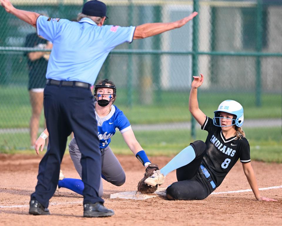 St. Joseph’s Riley Zache is safe at third base in the 5th inning of the championship game of the Class 3A Softball Sectional Thursday, May 26, 2022, at Newton Park in Lakeville.