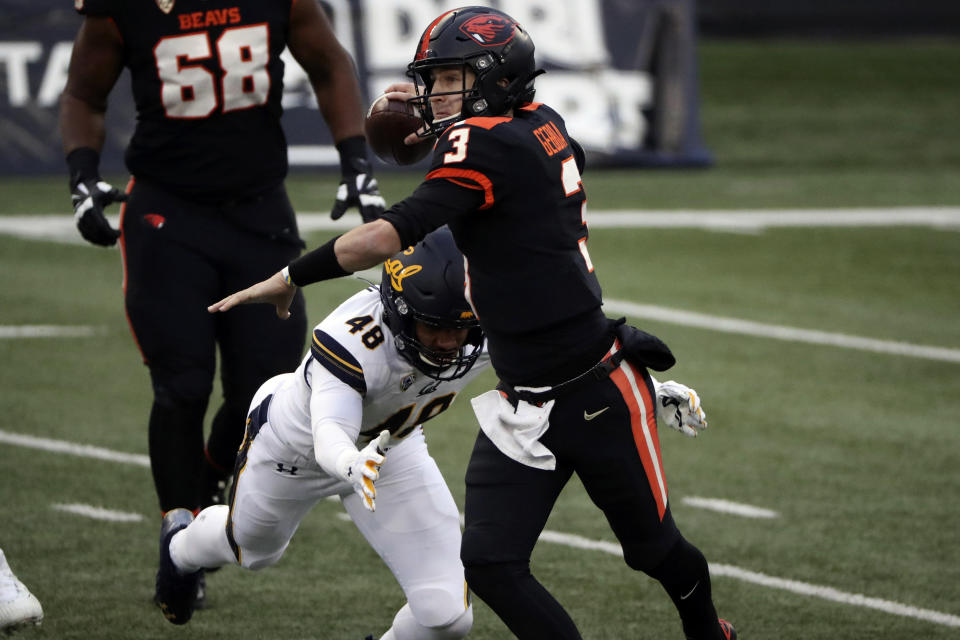 Oregon State quarterback Tristan Gebbia (3) throws a pass before being brought down by California outside linebacker Orin Patu (48) during the second half of an NCAA college football game in Corvallis, Ore., Saturday, Nov. 21, 2020. Oregon State won 31-27. (AP Photo/Amanda Loman)