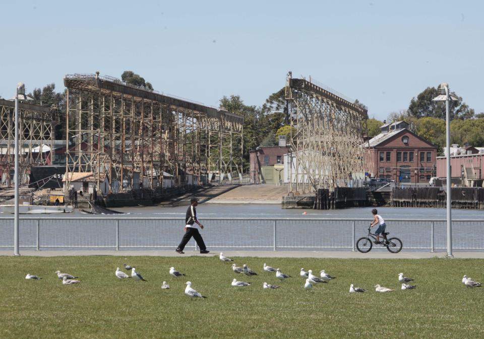 In this photo taken Thursday, July 19, 2012, the former Mare Island Naval Shipyard is seen in the background across from the Vallejo water front in Vallejo, Calif. After the 1996 closure of the naval yard and the burst of the housing bubble, Vallejo declared bankruptcy in 2008. The city emerged from bankruptcy last year and offers an example for what can come, both good and bad, from the experience. Some in the community say bankruptcy was the city's only option to climb out of a financial hole while others say more could have been done to avoid it.(AP Photo/Rich Pedroncelli)