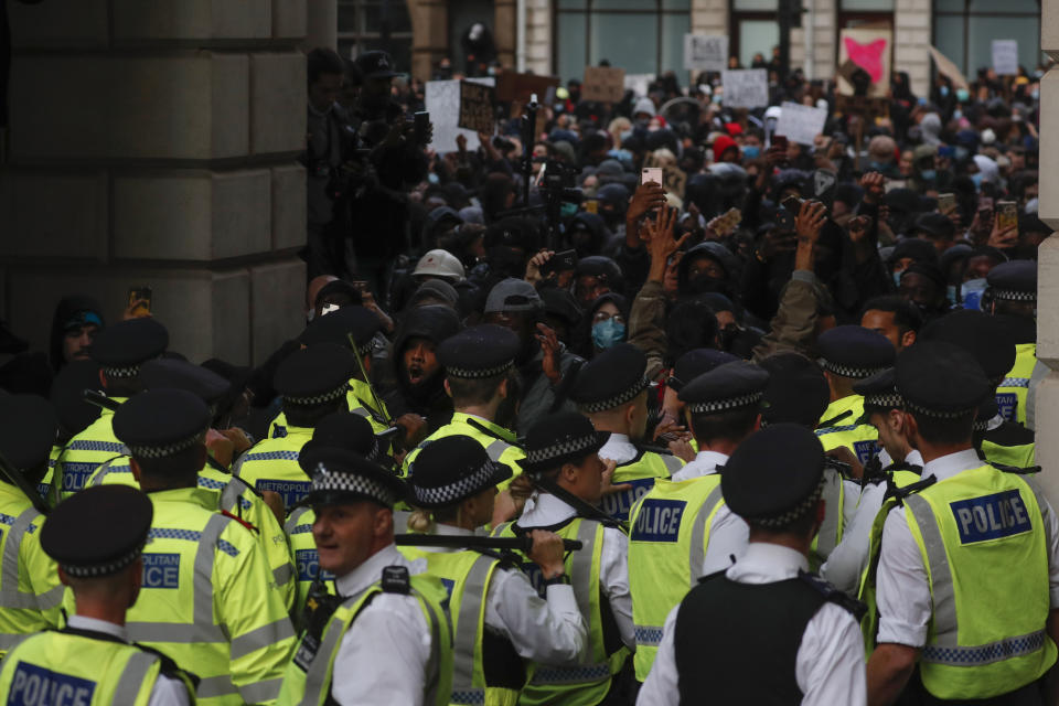 British police and protesters during the Black Lives Matter protest rally in London, Sunday, June 7, 2020. George Floyd rallies have been held around the world.