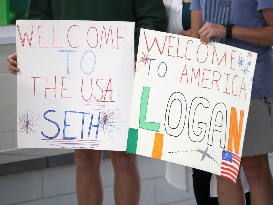 Host families held signs while waiting for the arrival of students from the Ulster Project on Monday, June 26, 2023, at Akron-Canton Airport.