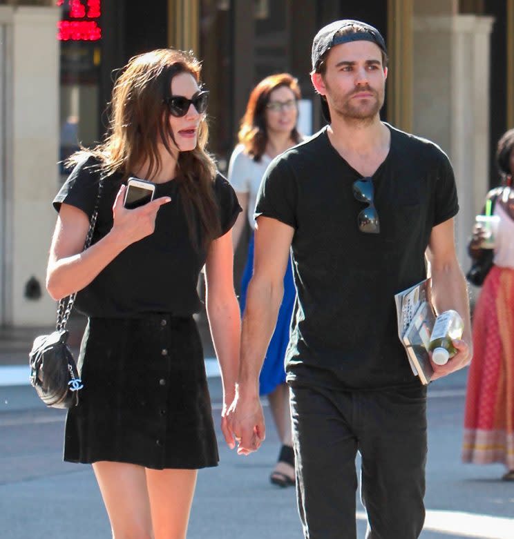 Phoebe Tonkin and Paul Wesley hold hands