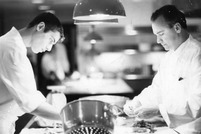 <p>Courtesy of Jean-Georges Restaurants</p> Jean-Georges Vongerichten cooking with his son Cedric