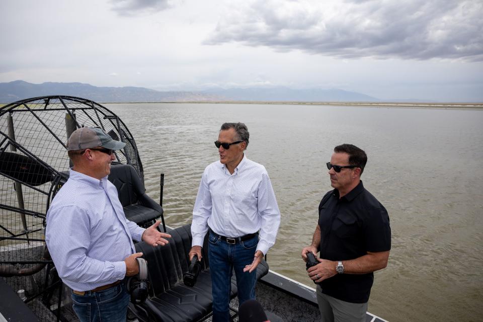 Utah Rep. Joel Ferry, R-Brigham City, Sen. Mitt Romney, R-Utah, and Utah House Speaker Brad Wilson, R-Kaysville, left to right, chat while on a fan boat tour on the Great Salt Lake on Aug. 19, 2022.