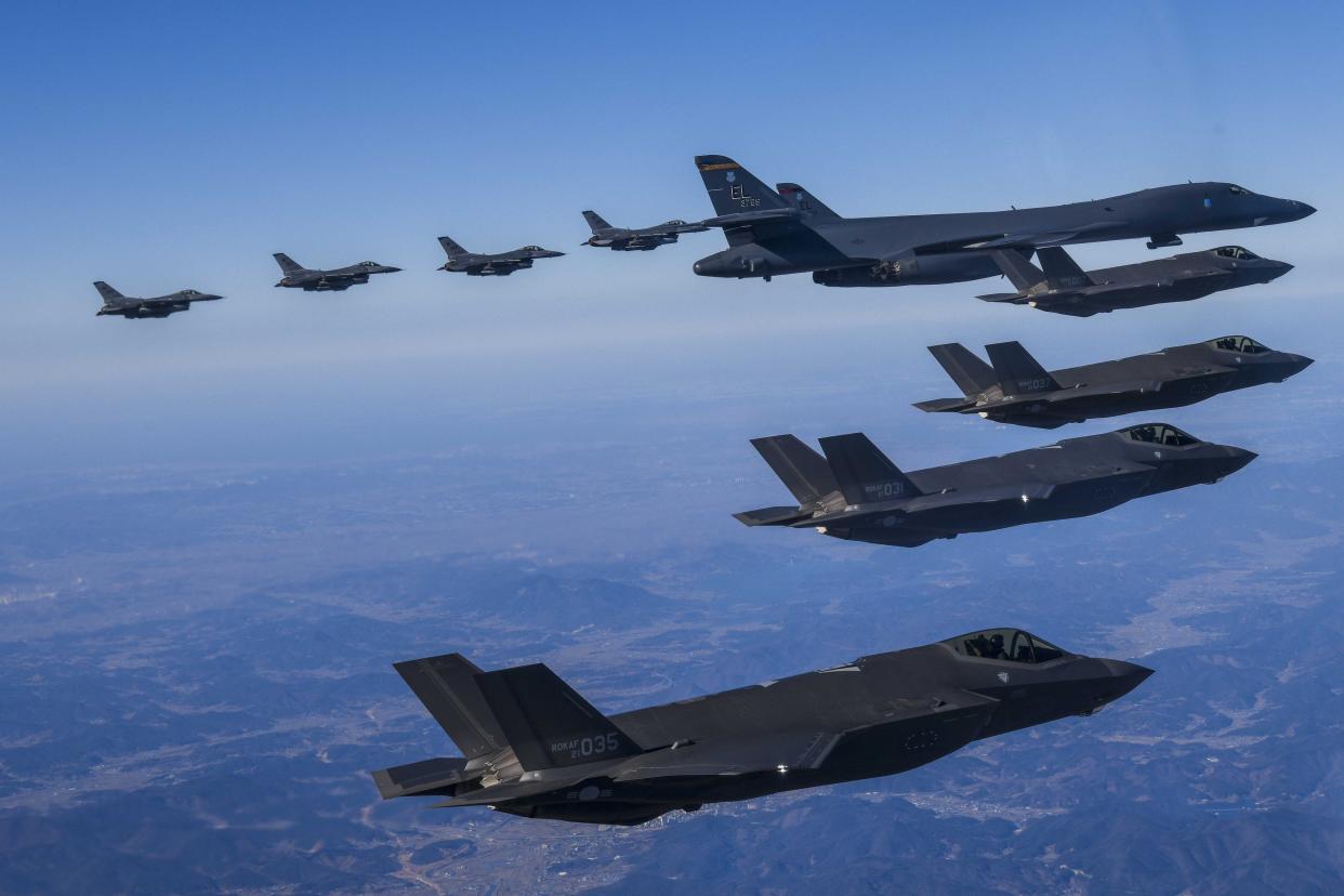 In this photo provided by South Korea Defense Ministry, a U.S. Air Force B-1B bomber, center, flies in formation with South Korea's Air Force F-35A fighter jets, bottom, and U.S. Air Force F-16 fighter jets, top, over the South Korea Peninsula during a joint air drill in South Korea, Sunday, Feb. 19, 2023. (South Korea Defense Ministry via AP)