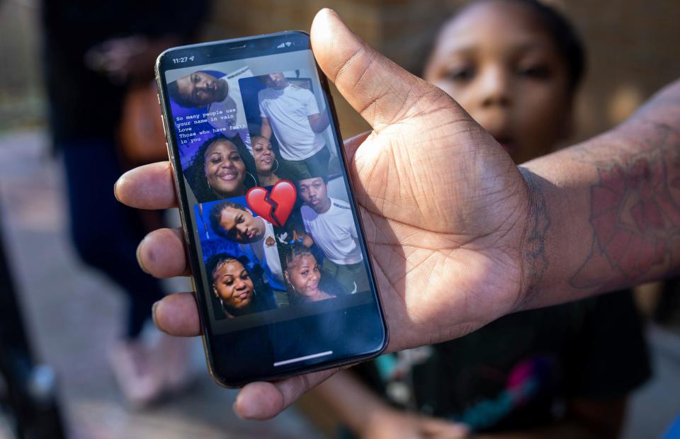 Star Arnold, a  family friend of Porter Burks, shows a photo of she and Burks as she stands outside the home where he lived in Detroit on Wednesday, Oct. 5, 2022. Burks was killed by police as he wielded a knife while experiencing a mental health crisis Oct. 2.