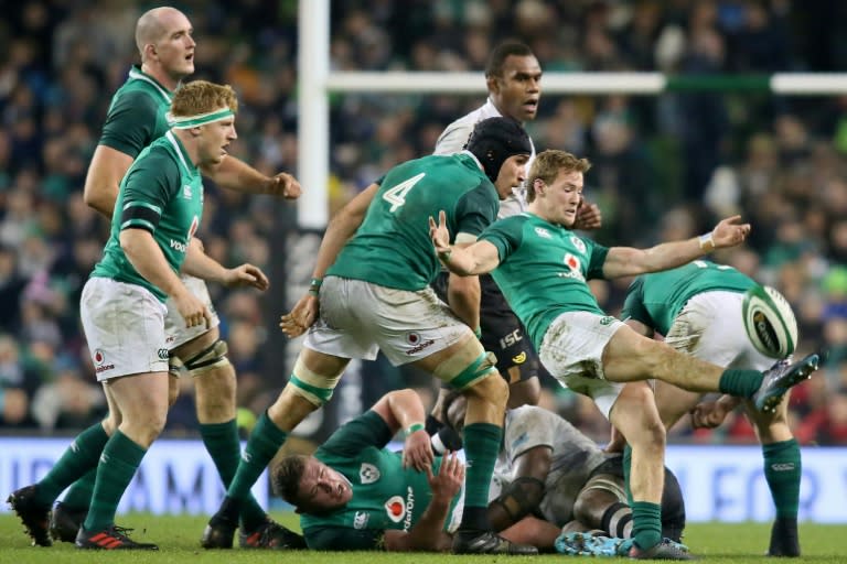 Ireland's scrum-half Kieran Marmion (R) kicks the ball up-field during their rugby union Test match against Fiji, at Aviva stadium in Dublin, on November 18, 2017