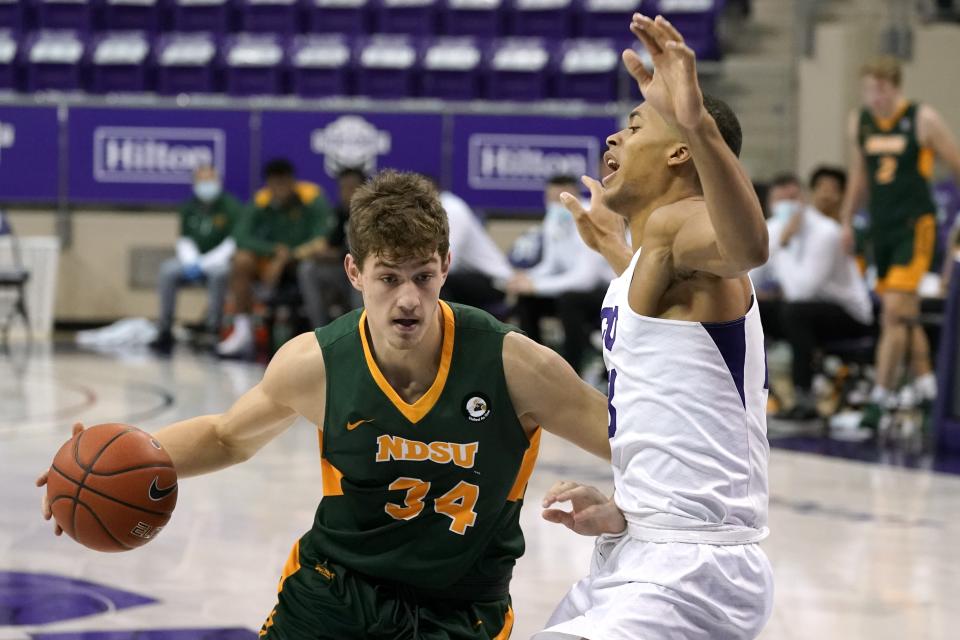 North Dakota State forward Rocky Kreuser (34) drives against TCU forward Jaedon LeDee (23) in the first half of an NCAA college basketball game in Fort Worth, Texas, Tuesday, Dec. 22, 2020. (AP Photo/Tony Gutierrez)