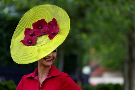 A racegoer poses for a photograph as she arrives on day one of the Royal Ascot horse racing meet, in Ascot, west of London, on June 18, 2019. (Getty Images)