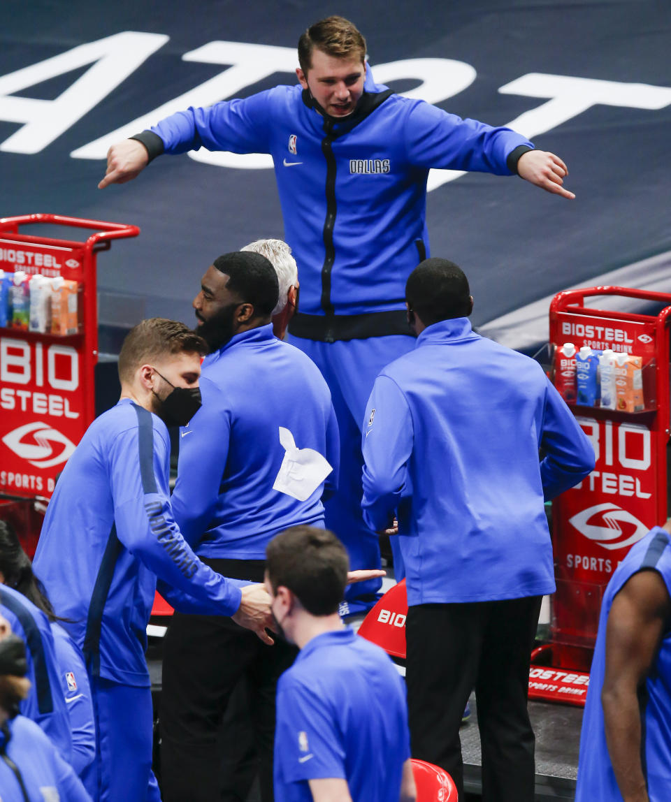 Dallas Mavericks guard Luka Doncic celebrates on the bench as the second half of an NBA basketball game against the Cleveland Cavaliers comes to an end, Friday, May 7, 2021, in Dallas. (AP Photo/Brandon Wade)