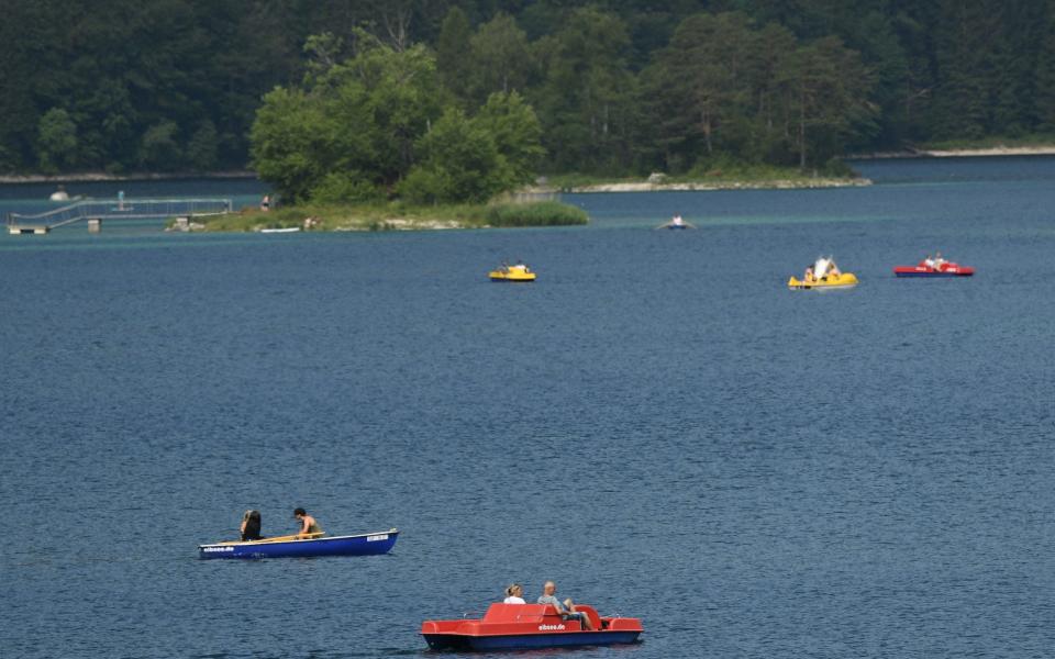 Boats float on the Eibsee lake near Garmisch-Partenkirchen, Germany - Shutterstock