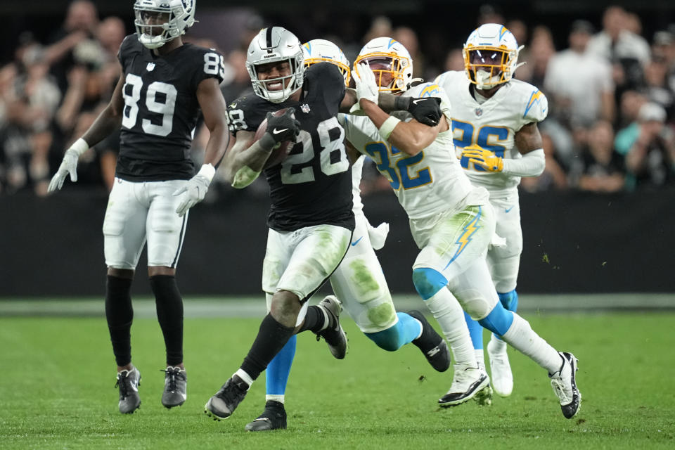 Las Vegas Raiders running back Josh Jacobs (28) rushes during overtime of an NFL football game against the Los Angeles Chargers, Sunday, Jan. 9, 2022, in Las Vegas. (AP Photo/Jeff Bottari)