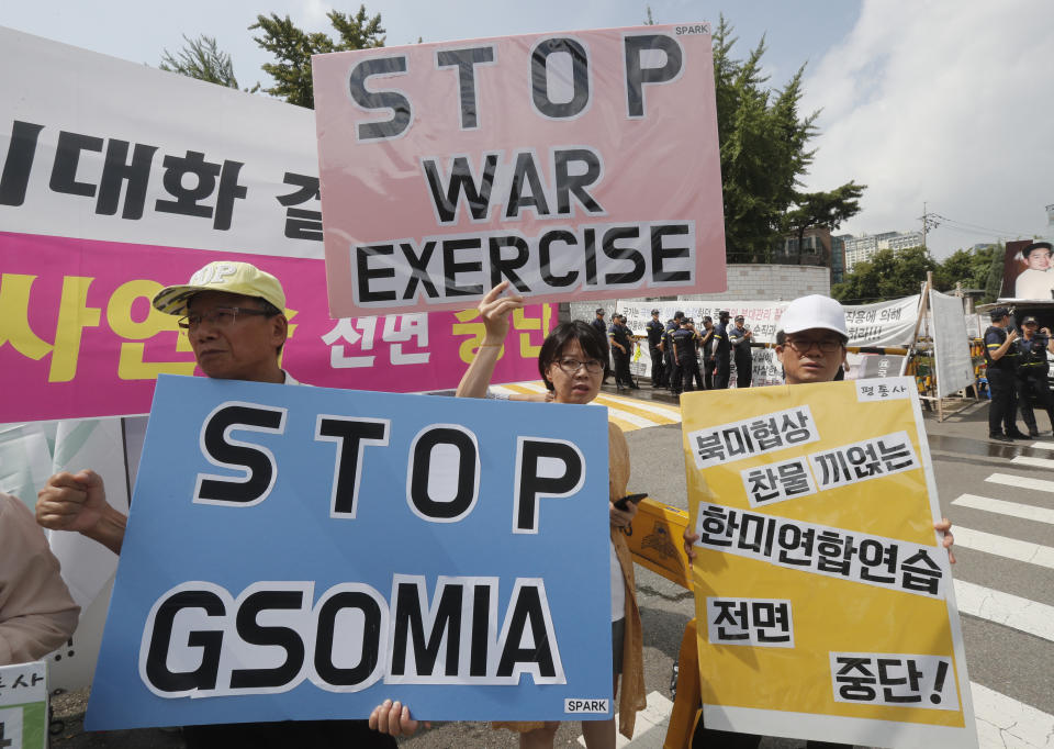 A South Korean protester holds a board reading the General Security of Military Information Agreement, or GSOMIA, an intelligence-sharing agreement between South Korea and Japan during a rally opposing a visit of U.S. Defense Secretary Mark Esper in front of the Defense Ministry in Seoul, South Korea, Friday, Aug. 9, 2019. Esper arrived in South Korea on Thursday for a two-day visit to discuss regional security and other alliance issues. The signs read: " We oppose a joint military exercises between South Korea and the United States." (AP Photo/Ahn Young-joon)