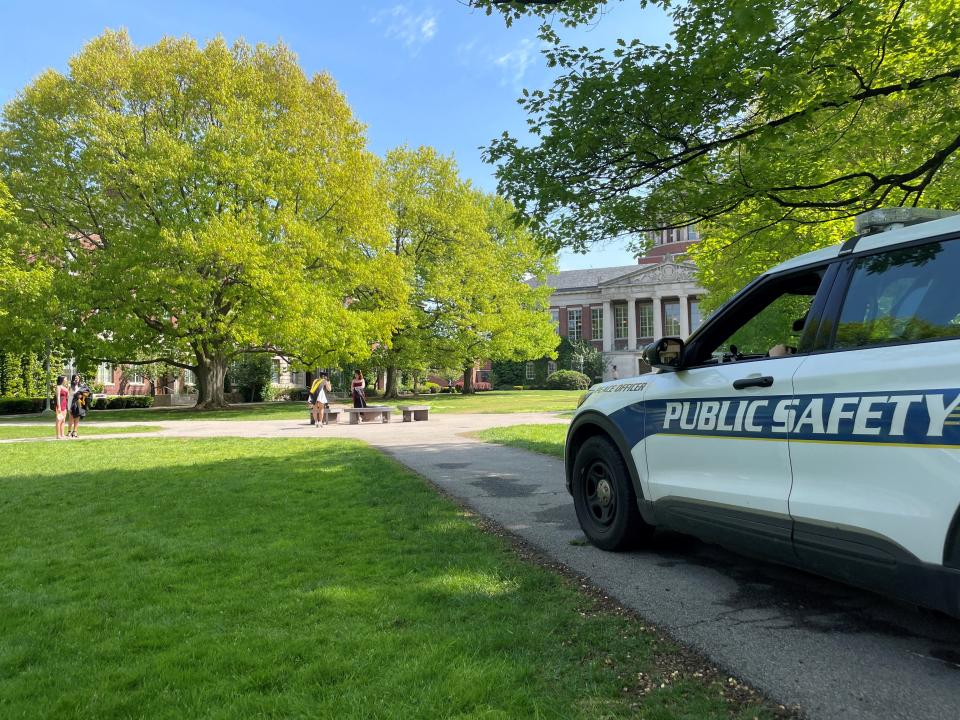 Students prepare for commencement at the University of Rochester on May 14, 2024, with Department of Public Safety officers stationed nearby.