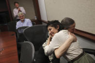 Cecilia Reyes, of the Chicago Tribune, is hugged by Kaarin Tisue, Chicago Tribune investigations editor, after winning the Pulitzer Prize in Local Reporting with Madison Hopkins of the Better Government Association, at the Chicago Tribune's Freedom Center in Chicago on Monday, May 9, 2022. (Jose M. Osorio/Chicago Tribune via AP)