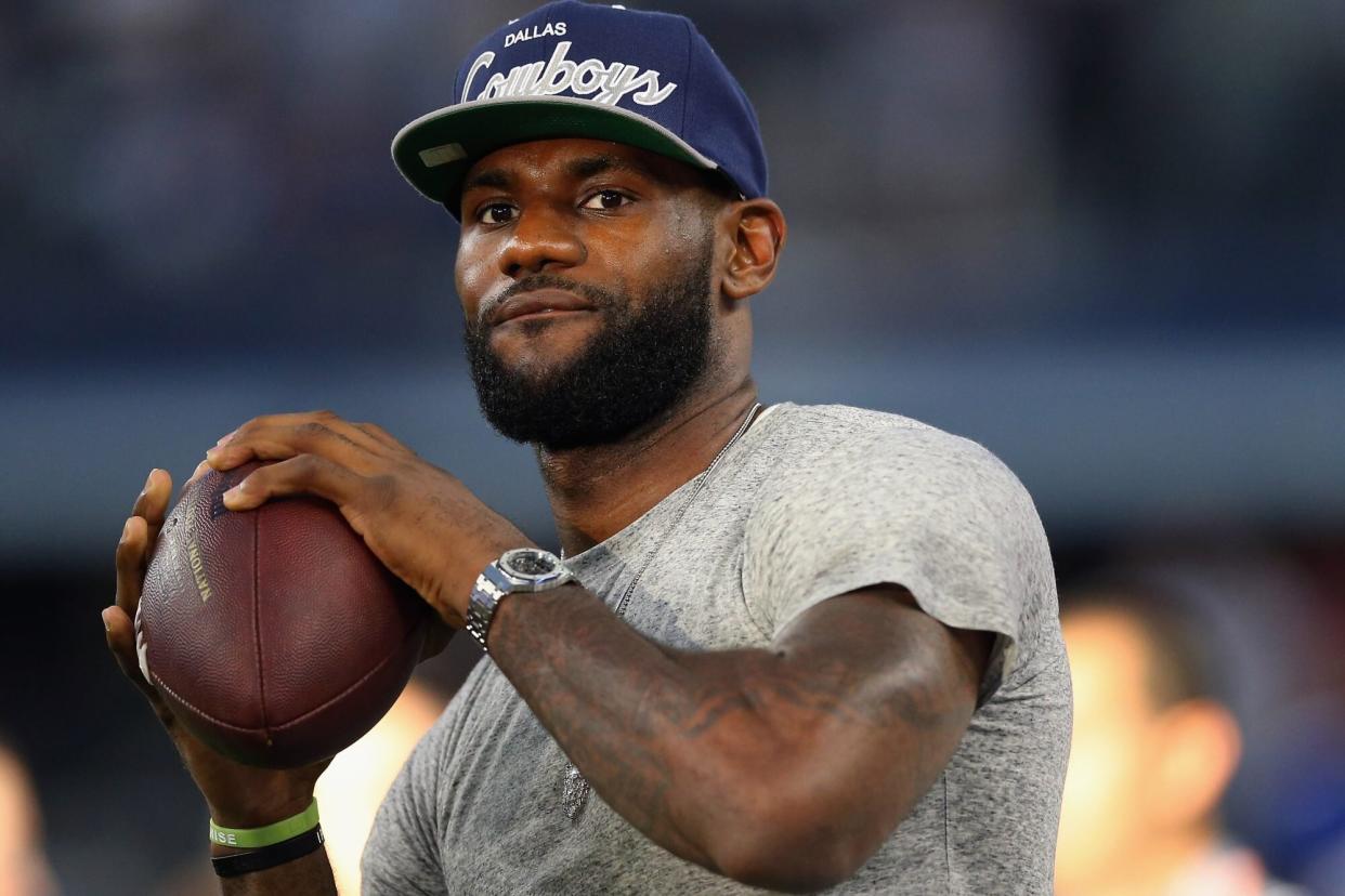 ARLINGTON, TX - SEPTEMBER 08: NBA player Lebron James of the Miami Heat throws a football at AT&T Stadium before a Sunday night game between the New York Giants and the Dallas Cowboys on September 8, 2013 in Arlington, Texas. (Photo by Ronald Martinez/Getty Images)