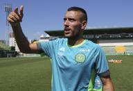 Chapecoense soccer team player Alan Ruschel gestures to supporters after a training session at the Arena Conda stadium in Chapeco, Brazil, Friday, Jan. 20, 2017. Ruschel is one of the six passengers that survived in the Chapecoense air crash, which killed 71 people, including 19 team players almost two months ago in Colombia. (AP Photo/Andre Penner)
