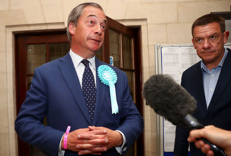 Brexit Party leader Nigel Farage speaks to the media outside the counting centre for the European Parliamentary election in Southampton, Britain, May 26, 2019. REUTERS/Hannah McKay