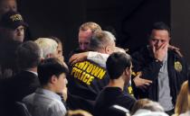 NEWTOWN, CT - DECEMBER 16: Newtown first responders received an emotional standing ovation as they entered the auditorium for a vigil at Newtown High School on December 16, 2012 at Newtown High School in Newtown, Connecticut. Twenty-six people were shot dead, including twenty children, after a gunman identified as Adam Lanza opened fire at Sandy Hook Elementary School. Lanza also reportedly had committed suicide at the scene. A 28th person, believed to be Nancy Lanza, found dead in a house in town, was also believed to have been shot by Adam Lanza. (Photo by Stephen Dunn-Pool/Getty Images)