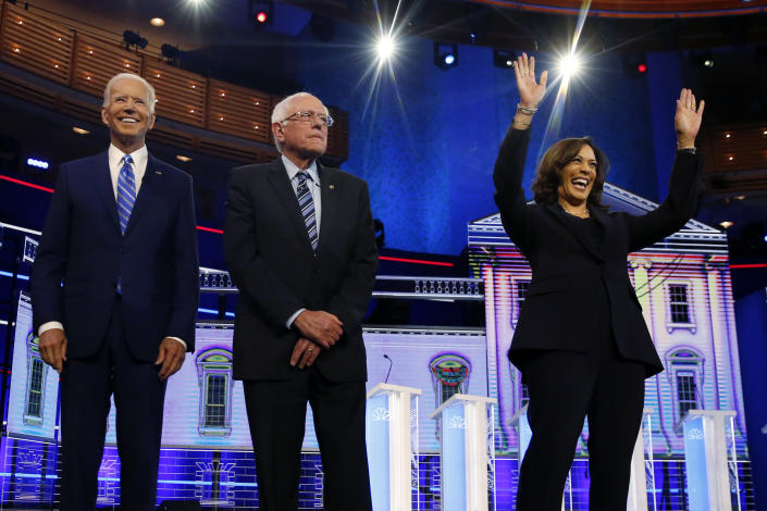 Democratic presidential candidates former vice president Joe Biden, left, Sen. Bernie Sanders, I-Vt., and Sen. Kamala Harris, D-Calif., right, stand on stage for a photo op before the start of the the Democratic primary debate hosted by NBC News at the Adrienne Arsht Center for the Performing Arts, Wednesday, June 27, 2019, in Miami. (AP Photo/Wilfredo Lee)