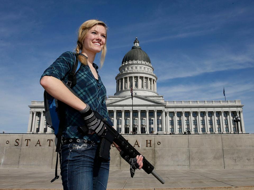 A woman holds an AR-15 at a gun rights rally at the Utah State Capitol in 2013.