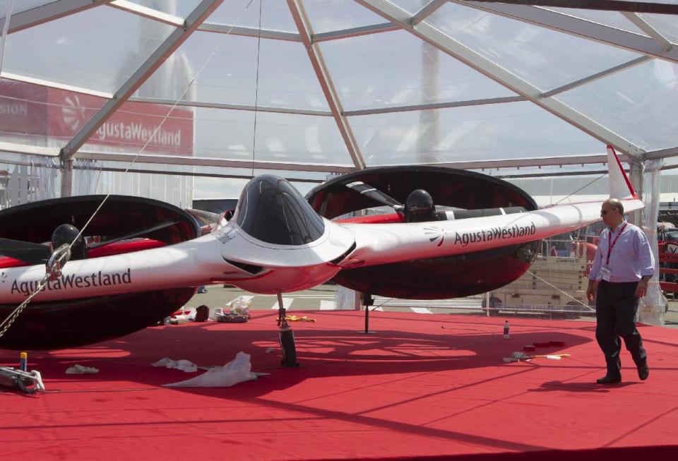 A man walks past the Aircraft Agusta Westland “Project Zero” all-electric tiltrotor technology on display for the Paris Air Show in le Bourget, North of Paris, Sunday, June 16, 2013. The Paris Air Show will open on June 17 at Le Bourget. (AP Photo/Jacques Brinon)