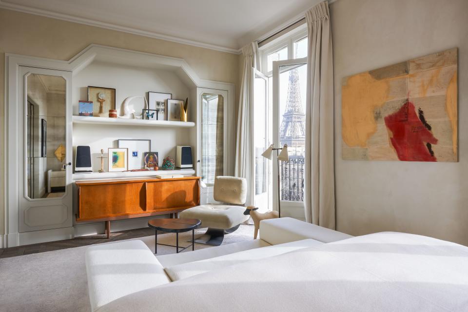A lamb sculpture by François Xavier LaLanne stands watch in the master bedroom. Oscar Niemeyer chair; Georges Jouve cocktail table; Charlotte Perriand console.