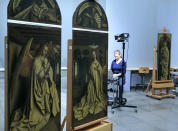 A restorer inspects one of the 24 framed panels of the Altarpiece or Adoration of the Mystic Lamb at The Genth Museum of Fine Arts October 2, 2012. The painting, considered to be one of Belgium's masterpieces and one of the world's treasures, and which was completed in 1432 by brothers Hubert and Jan van Eyck, will be restored over a five-year period. REUTERS/Yves Herman