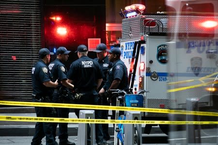 New York City Police Department officers are seen near the Fulton Street subway station as police said they were investigating two suspicious packages in Manhattan