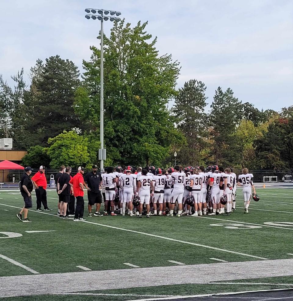 Simpson University gathers at the 30-yard line for a postgame meeting after its first football scrimmage at George Fox University on Sunday, Sept. 17, 2023.