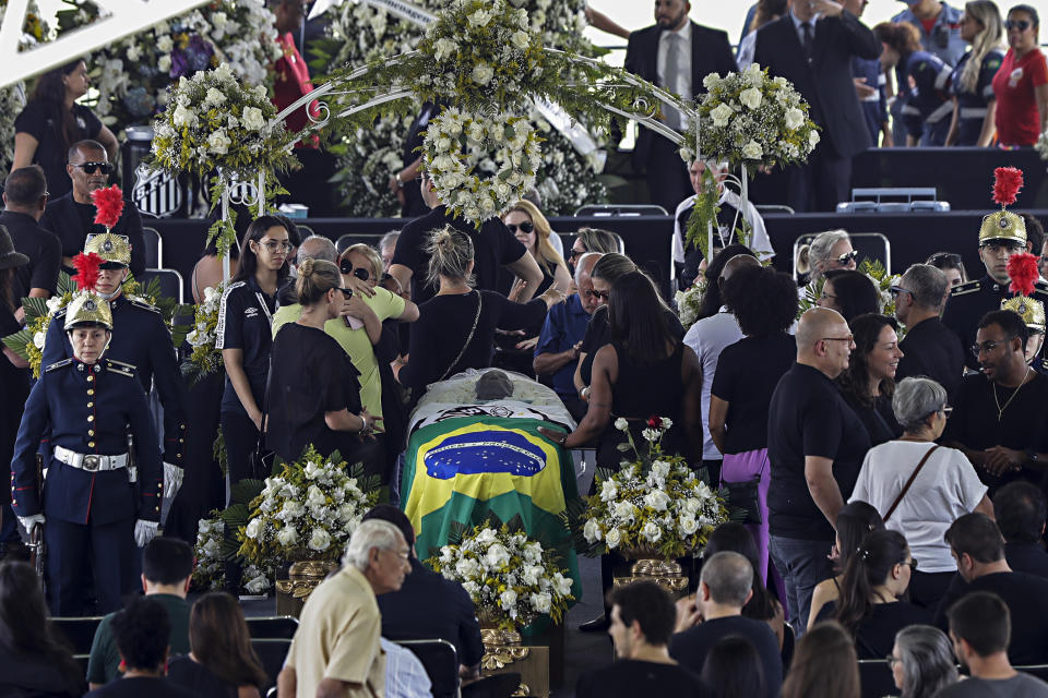 People pay their last respects to the late Brazilian soccer great Pele whose lies in state at Vila Belmiro stadium in Santos, Brazil, Monday, Jan. 2, 2023. (AP Photo/Marcelo Chello)