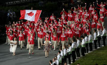 LONDON, ENGLAND - JULY 27: Simon Whitfield of the Canada Olympic triathlon team carries his country's flag during the Opening Ceremony of the London 2012 Olympic Games at the Olympic Stadium on July 27, 2012 in London, England. (Photo by Clive Rose/Getty Images)