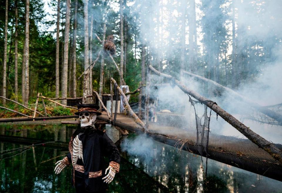 A fog machine fills the air with fog as a fake skeleton stands in a pond along the mile long trail at My Haunted Forest at Grand Farms in Vaughn, Wash. on Oct. 23, 2022.